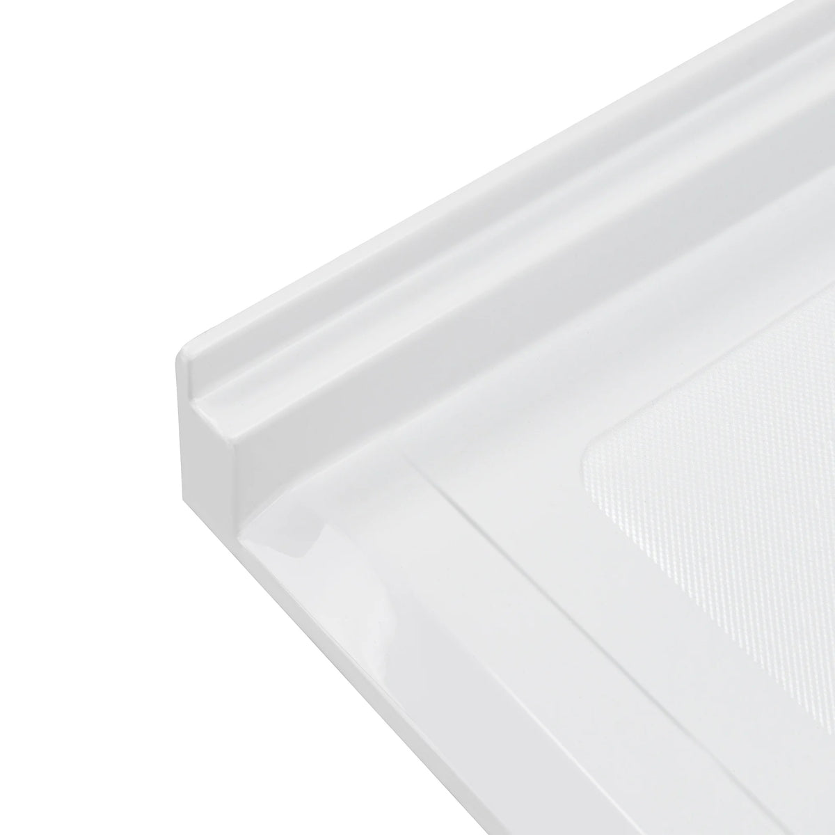 A high-angle, close-up shot of the corner of a white acrylic shower base, showing the smooth, vertical tiling flange and the raised, square outer edge. A portion of the textured, slip-resistant floor surface is visible on the right, contrasted against the glossy finish of the surrounding frame.