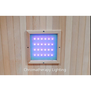 The image displays the chromatherapy lighting system integrated into the wooden wall paneling of the sauna, featuring a square light panel embedded with glowing purple LED bulbs.