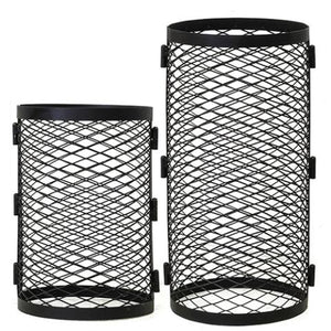 Two black stainless steel chimney cover grids are shown side by side against a white background. Both are hollow, cylindrical cages made of a delicate, crisscrossed diamond-pattern wire mesh, finished with solid black metal bands around the top and bottom openings. The cylinder on the right is notably taller than the one on the left. Small rectangular mounting brackets are fixed vertically along the outer seams of each grid.