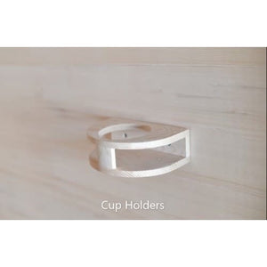 A close-up shot of a small, semi-circular wooden cup holder mounted on a light wood wall panel inside a sauna, with the caption 'Cup Holders' at the bottom.