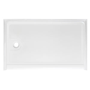 Top-down view of a rectangular, low-profile white shower base. The floor of the base has a subtle anti-slip texture pattern. There is a single circular drain hole located on the far left side. The base is surrounded by a low integrated lip or flange to contain water, viewed against a plain white background.
