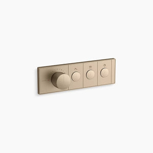 A horizontal, rectangular Kohler K-26347-9 Anthem mechanical thermostatic valve control in brushed bronze, angled slightly right against a white background. The sleek faceplate features four cylindrical knobs in a row. The first knob on the left is much larger and thicker, surrounded by small indicator dots for temperature. To its right are three smaller, identical control knobs, each centered within a rectangular segment containing a small icon above it.