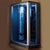 Mesa 803L Steam Shower slightly curved front, sliding glass doors, and brushed nickel trim tempered blue glass and dual interior control panels with dual shower wands, dual fold up corner seats and a blue LED lighting