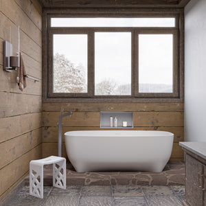 ALFI AB2728 Floor Mounted Tub Filler + Mixer with additional Hand Held Shower Head brushed nickel beside the bathtub in the bathroom