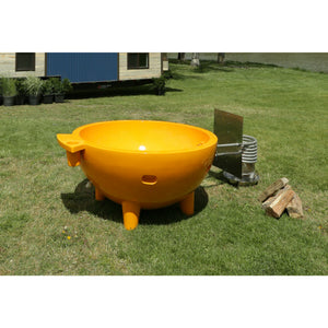 Orange ALFI FireHotTub The Round Fire Burning Portable Outdoor Hot Bath Tub made of acrylic and reinforced with a fiberglass core, Flat feet, stainless steel windscreen panels and ledge in the garden