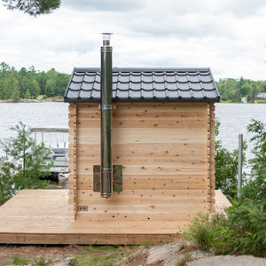 Dundalk Canadian Timber Georgian Cabin Sauna CTC88W - Eastern White Cedar with bronze tempered glass with wooden frame door and windows - with Harvia Chimney & Heat Shield set on side wall sauna - Outdoor setting - Vital Hydrotherapy