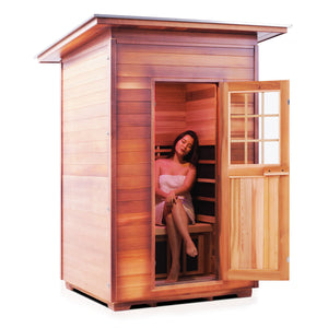 Enlighten Sauna InfraNature Original Infrared Outdoor Canadian red cedar slope Roofed two person sauna with young woman model side view