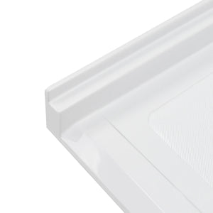 A high-angle, close-up shot of the corner of a white acrylic shower base, showing the smooth, vertical tiling flange and the raised, square outer edge. A portion of the textured, slip-resistant floor surface is visible on the right, contrasted against the glossy finish of the surrounding frame.