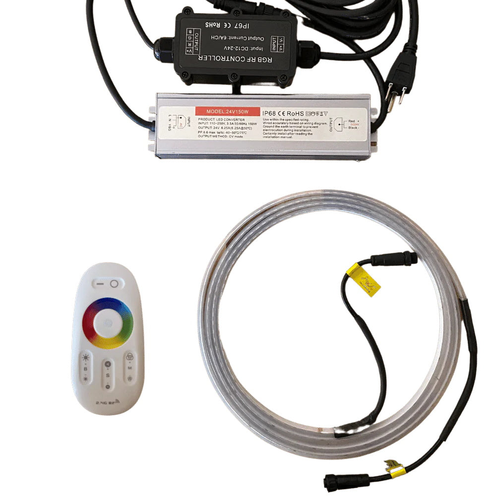 An LED strip light kit is displayed against a white background, containing a coiled clear light strip with black connector wires, a white handheld remote control with a color wheel, a silver rectangular power supply, and a black RGB RF controller box with attached power cords.