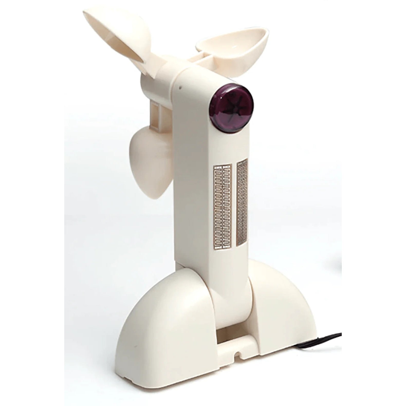 A white plastic anemometer stands on a white surface, featuring a three-cup rotor at the top, a vertical column with a purple circular lens and a small grid sensor pattern, and a wide curved base.