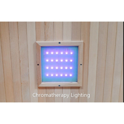 The image displays the chromatherapy lighting system integrated into the wooden wall paneling of the sauna, featuring a square light panel embedded with glowing purple LED bulbs.
