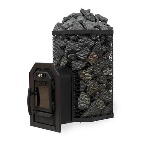 A Cozy Heat Thru-Wall wood-burning sauna stove is shown from an angled perspective against a plain white background. The unit features a tall, octagonal black wire mesh cage packed to the top with grey sauna stones. Extending forward to the left is the structural firebox tunnel designed for through-wall installation, ending with a black cast-iron door. The door includes a closed glass viewing window, a handle on the left side, and the embossed "COZY" brand name above the glass.