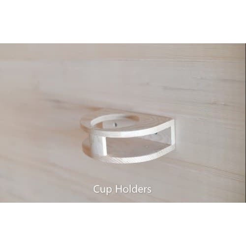 A close-up shot of a small, semi-circular wooden cup holder mounted on a light wood wall panel inside a sauna, with the caption 'Cup Holders' at the bottom.