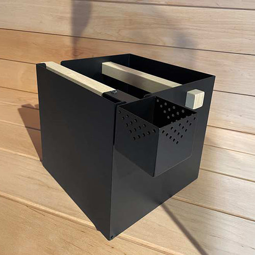 Black rectangular sauna heater with open perforated side vent panel exposing internal wood elements.
