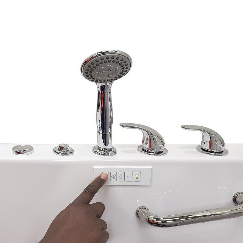 Close-up of a hand pressing a button on the control panel of a white walk-in bathtub, with chrome handheld shower, faucet handles, and grab bar visible.