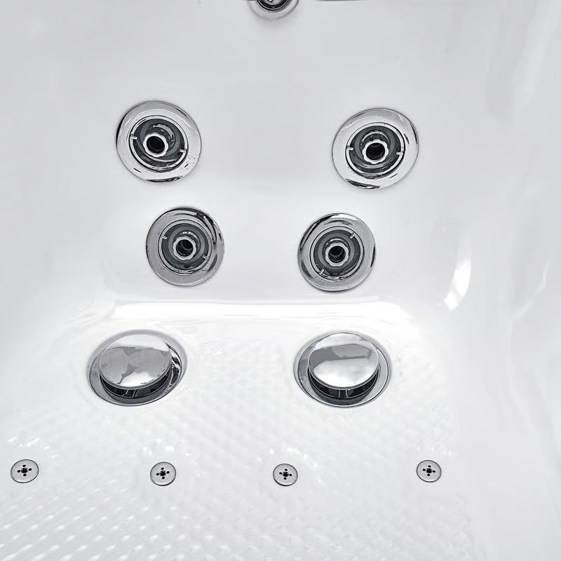 Close-up of chrome hydrotherapy jets and textured seat floor inside a white walk-in bathtub.