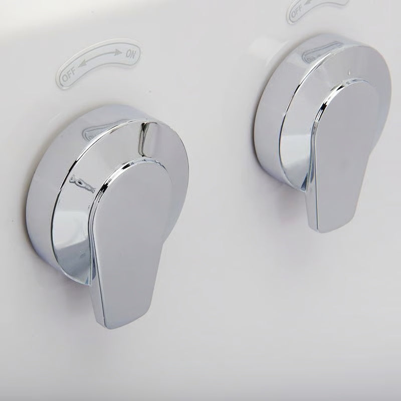 Close-up of two chrome off/on jet control valves on the wall of a white walk-in bathtub.