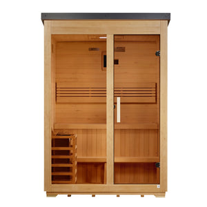 A straight-on, eye-level view of the same rectangular wooden sauna cabin. The front features two symmetrical halves: a fixed glass pane on the left and a glass door on the right with a vertical wooden handle and dark metal hinges. Inside, horizontal light-tan wood planks line the walls. A two-tier bench spans the width, backed by a horizontal slatted backrest. On the bottom left sits a small wooden-slat cage enclosing a heater. A digital panel and small warning labels are centered on the upper back wall.