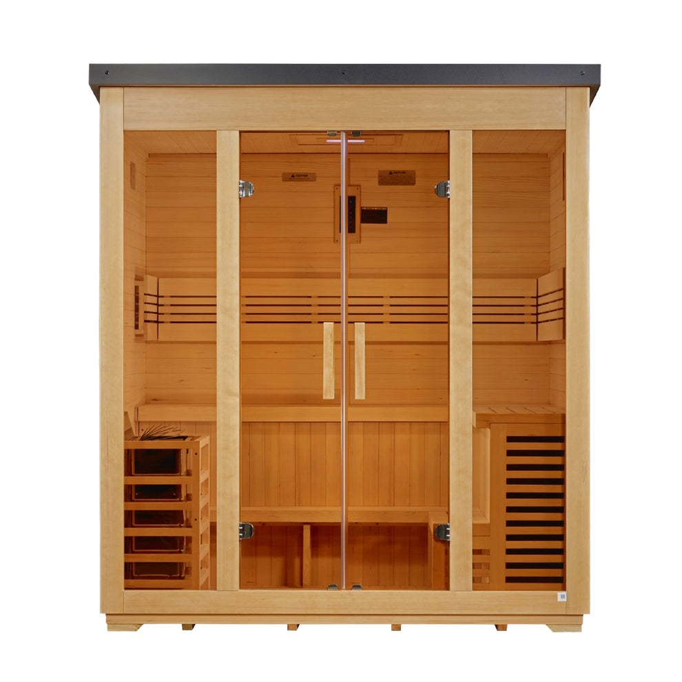 A straight-on, front view of a large, rectangular wooden sauna cabin with light-tan planks and a flat, dark gray metal roof. The facade features four glass panels: two fixed outer windows and two central glass doors with vertical wooden handles. The interior shows a symmetrical layout with a two-tier bench wrapping around the back and side walls. A small wooden-slat heater cage is on the bottom left, and a matching slatted, dark-vented wooden console sits on the bottom right.