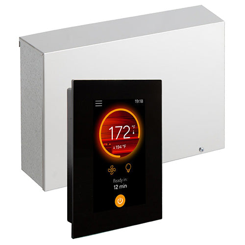 A rectangular, matte-black digital control panel stands in the foreground, angled slightly to the left. Its screen features a prominent orange ring displaying a temperature reading of "172°F," with small fan and lightbulb icons below, and a glowing orange power button at the bottom. Positioned behind it on a plain white background is a large, rectangular metallic silver control box with a clean, brushed metal finish, completing the hardware set.