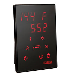 Close-up product shot of a black Harvia Xenio digital control panel against a white background. The rectangular, vertical device features a smooth glass surface illuminated with red digital readouts and touch-sensitive icons, displaying "144 F" at the top and "5:52" below it. Additional illuminated icons include a minus button, a plus button, a "MENU" button, power symbols, and the "HARVIA" brand logo near the bottom right.