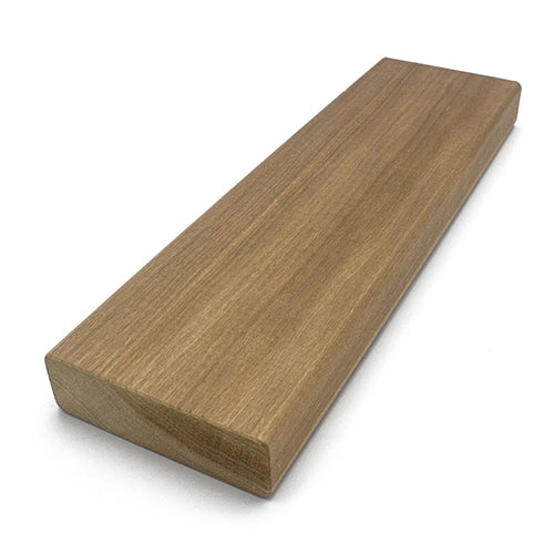 A rectangular wood plank viewed from a three-quarter perspective, displaying the smooth top surface, long edge, and textured cross-section end grain on the left.