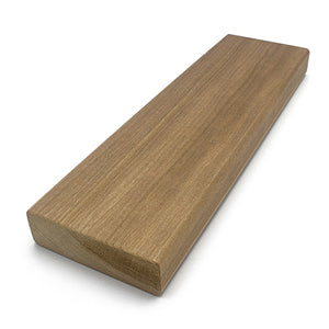 A rectangular wood plank viewed from a three-quarter perspective, displaying the smooth top surface, long edge, and textured cross-section end grain on the left.