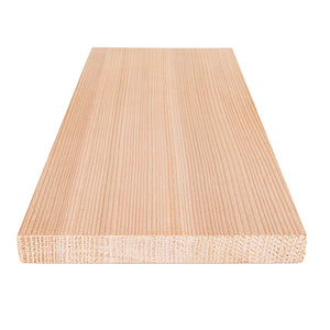 A rectangular light-colored wood board laying flat on a white surface, shown from a front-facing perspective angle extending into the background to display its dense, straight vertical grain lines.