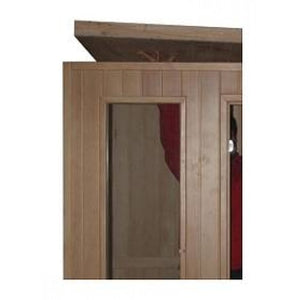 The image shows the upper section and roof panel being fitted onto the vertical wooden wall panels during the assembly of the sauna structure.