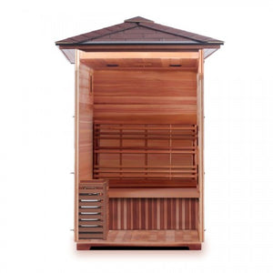 The open front view of the SunRay Eagle 2-Person Outdoor Traditional Wet/Dry Sauna (HL200D1) displays its spacious interior layout, highlighting the wooden flooring, the bench seating with a slatted backrest, the heater enclosed in a protective wooden guard on the left, and the paneled ceiling with lighting fixtures beneath the pitched shingle roof.