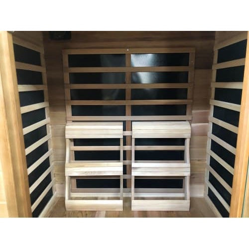 An interior perspective of the SunRay Sierra 2-Person Indoor Infrared Cedar Sauna (model HL200K_5), showing individual slanted wooden backrests positioned in front of the rear heating panel, flanked by side heating panels and cedar wood walls.