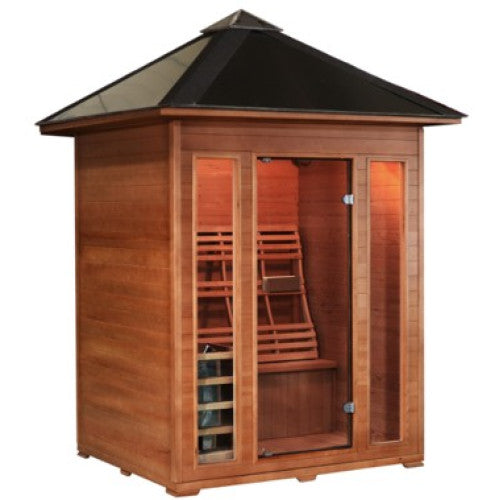 The image displays the SunRay Waverly 3-Person Outdoor Traditional Sauna with Harvia Heater (HL300D2), featuring a natural wood construction, a dark pyramid-pitched metal roof with an overhang, a full-glass front door, and narrow vertical glass panels framing the front facade.