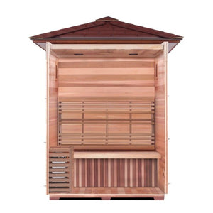 The image shows a cross-section interior view of the outdoor traditional sauna, highlighting the natural wood paneling, the upper backrest, the main bench seating, the slatted lower front panel, the floorboards, and the electric heater positioned on the left side.