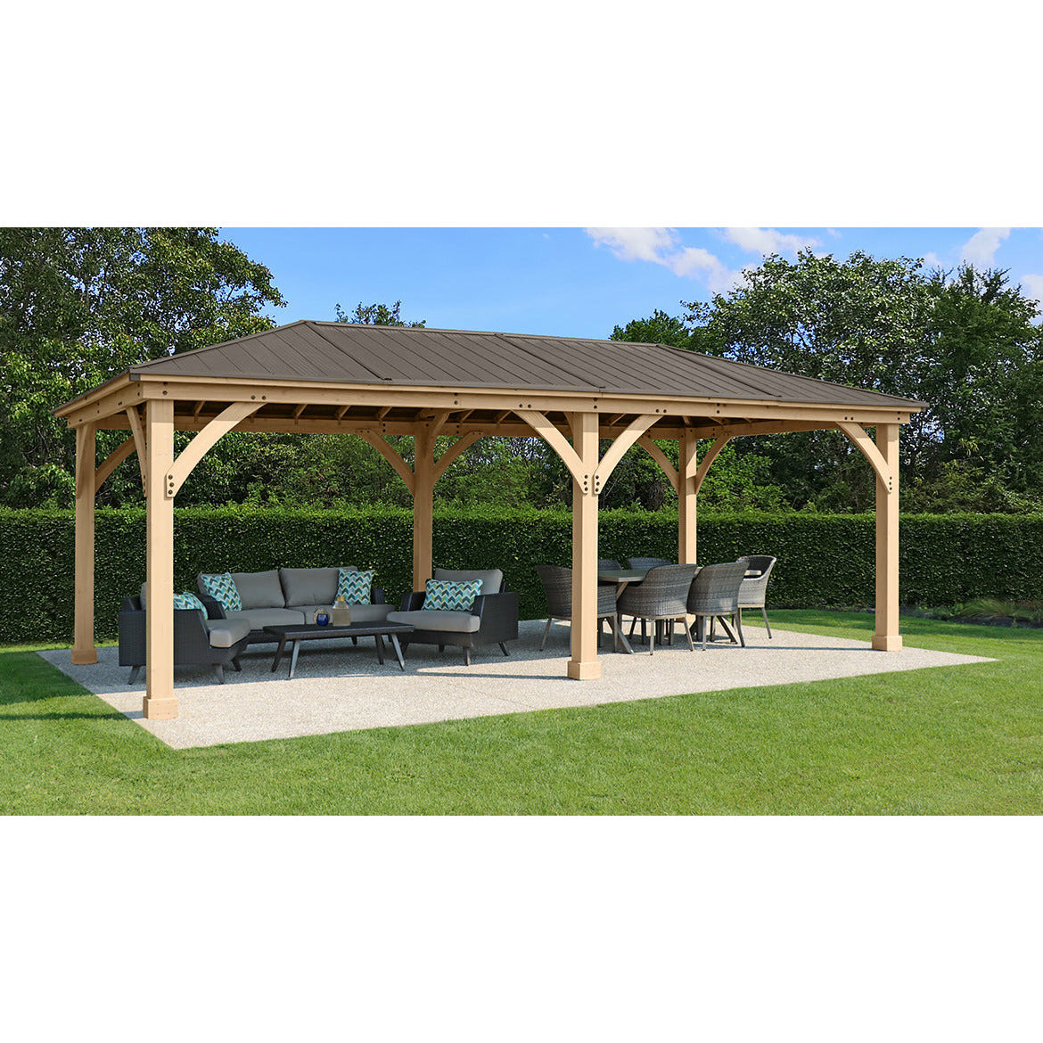 12 x 24 Meridian Gazebo - exterior grade cedar coated in natural cedar-color stain with coffee brown colored aluminum roof, 6” x 6” Posts with classic plinths, Heavy, curved corner gussets placed in a garden isometric view