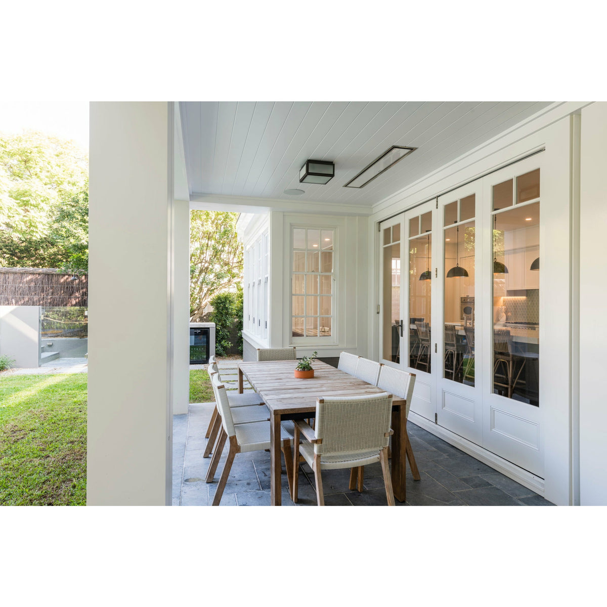 2300W Platinum Smart-Heat Electric Heater in White Stainless Steel Tinted Glass-Ceramic Screen Slim-line Design mounted in a ceiling of a dining area