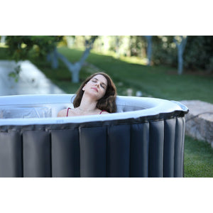 MSpa Delight Series Silver Cloud Inflatable Spa - elegant round design and clean lines with one female relaxing located outdoor