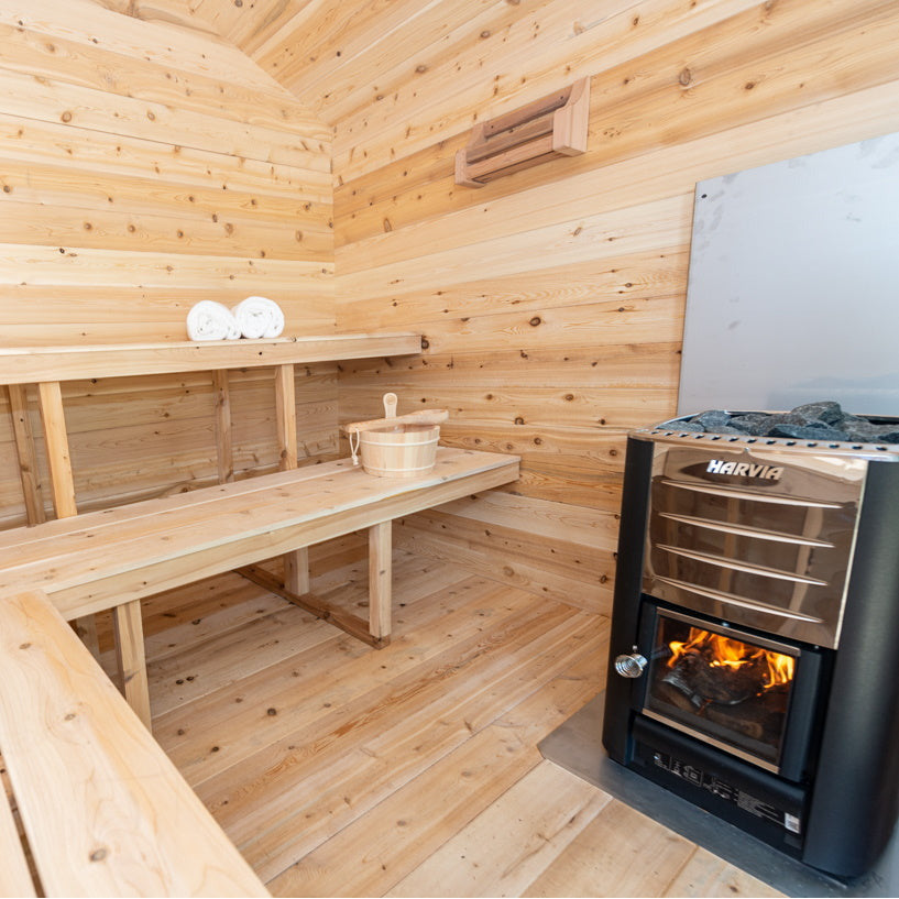 Dundalk Canadian Timber Georgian Cabin Sauna CTC88W - Eastern White Cedar - with Solid Cedar Wood Benches, bucket & ladle, harvia heater, cedar bottle shelf, two white towels - Inside view