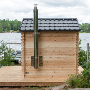 Dundalk Canadian Timber Georgian Cabin Sauna CTC88W - Eastern White Cedar with bronze tempered glass with wooden frame door and windows - with Harvia Chimney & Heat Shield set on side wall sauna - Outdoor setting - Vital Hydrotherapy