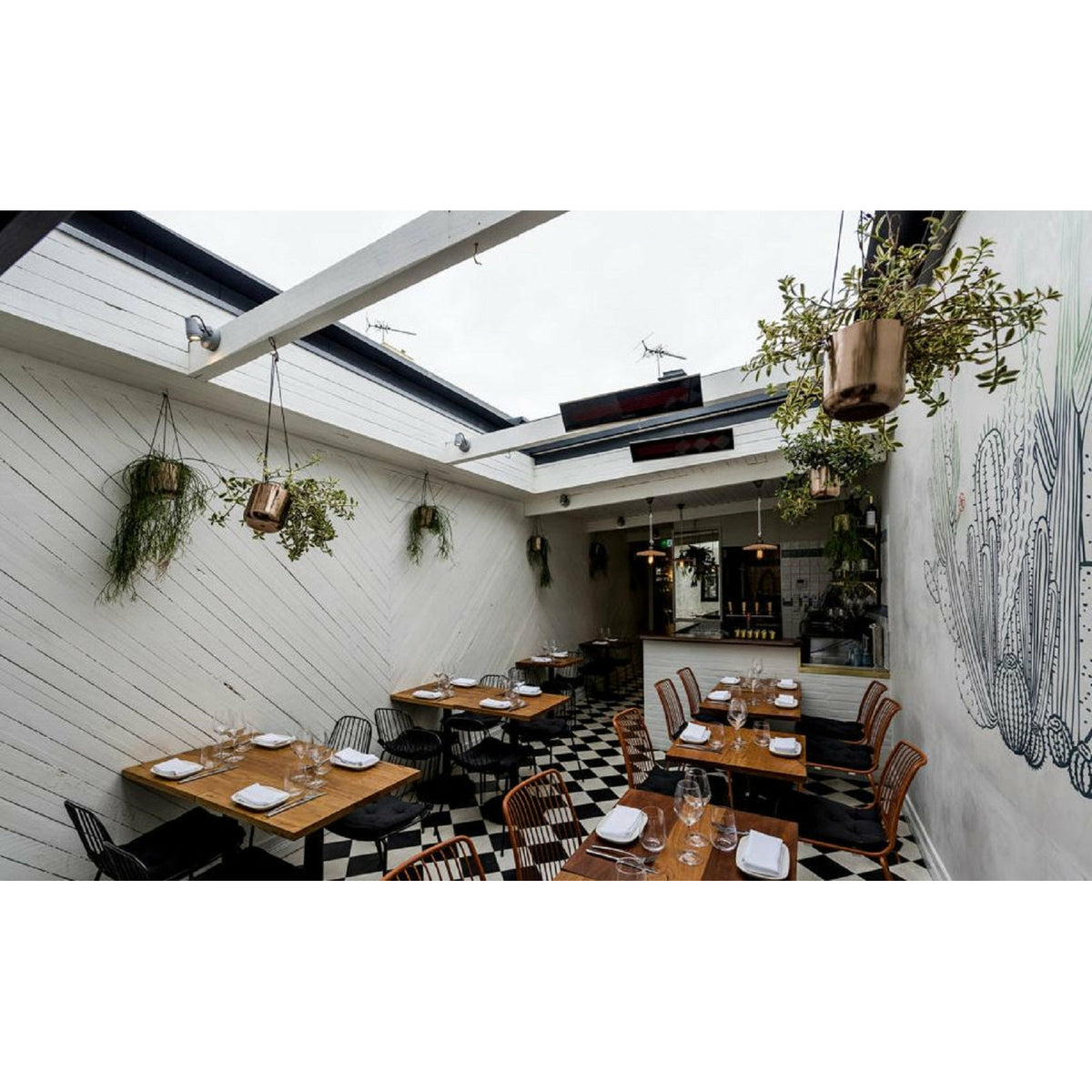 2300W Platinum Smart-Heat Electric Heater in Black Stainless Steel Tinted Glass-Ceramic Screen Slim-line Design mounted in ceiling of a cafeteria