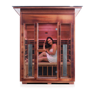 InfraNature Original Rustic Infrared Sauna Canadian red cedar inside and out with slope roof and glass door and windows with young woman model front view