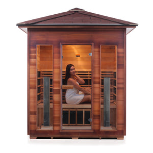 Rustic Infrared Sauna Canadian red cedar inside and out with peaked roof and glass door and windows with young woman model front view