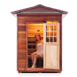 Enlighten Sauna InfraNature Original Infrared Outdoor West Canadian red cedar inside and out 3 person sauna with peak roof and woman model inside front view