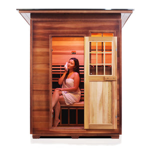 Enlighten Sauna InfraNature Original Infrared Outdoor West Canadian red cedar inside and out 3 person sauna open door with slope roof and woman model inside