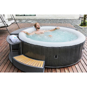 MSpa Comport Set - Two headrests and one cup holder - light grey - with one male relaxing in the round spa located outdoor